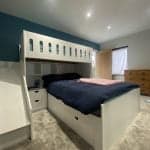 L-shaped bunk bed with double on bottom and single on top with storage compartments